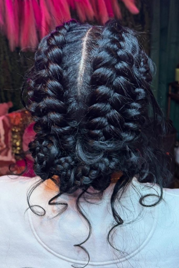 Feed-in butterfly braids in dark hair with loose curly ends