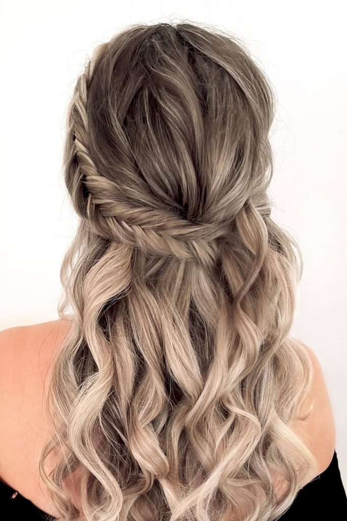 Half up half down hair with a braid: boho fishtail across soft curls