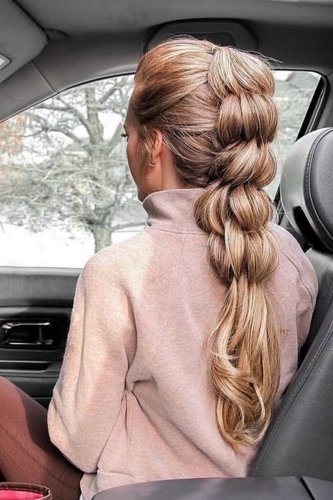 Chunky pull-through braid in a high ponytail seen from the car window