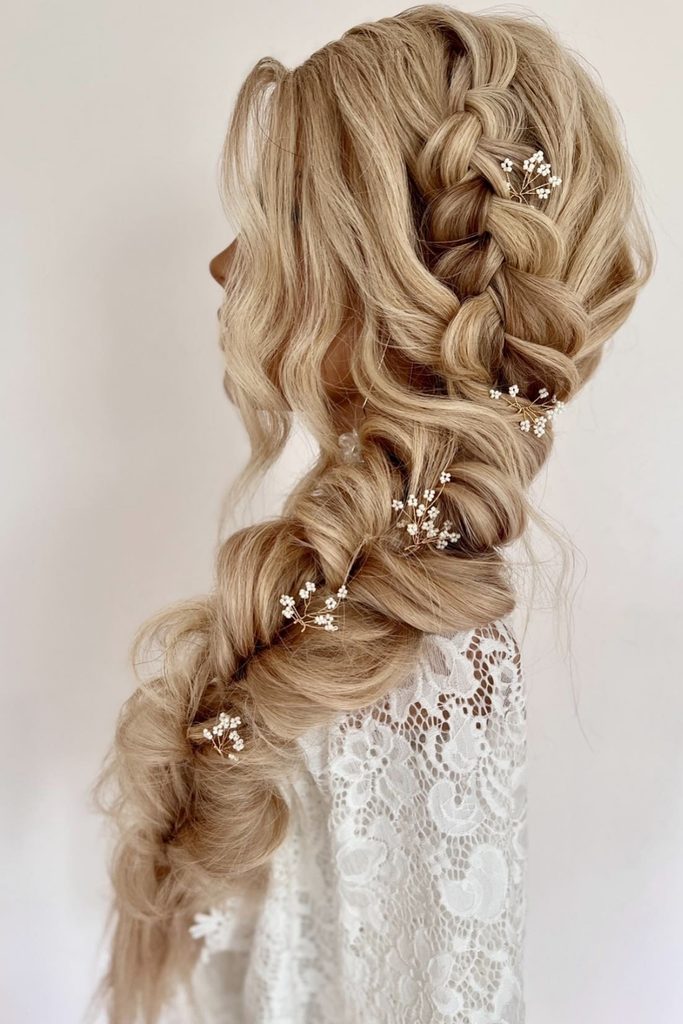 Chunky side braid dotted with baby's breath, styled for a winter wonderland wedding