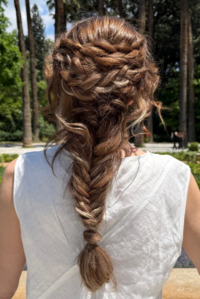 Messy boho braid with soft, wrapped crown sections and a loose fishtail finish