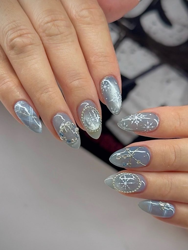 Blue winter nails with silver chrome snowflakes