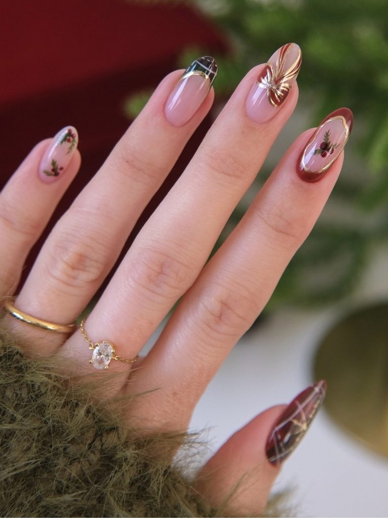 Sheer nude winter nail ideas with gold details and burgundy accents