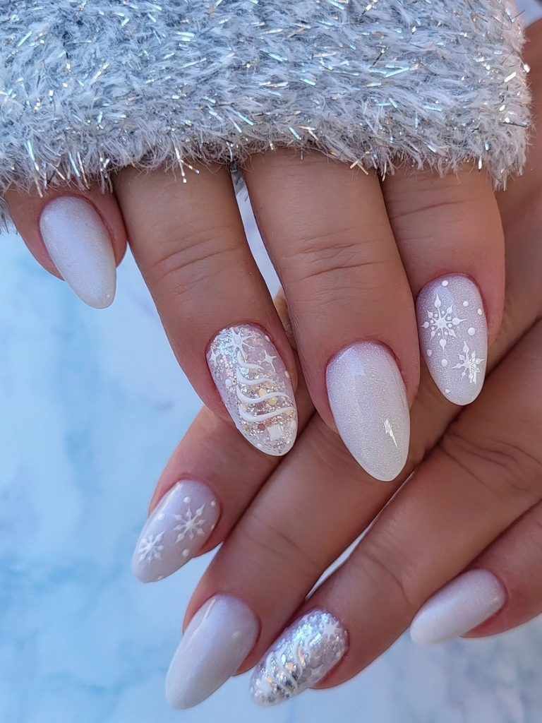 White snowflake nails on milky white almond nails
