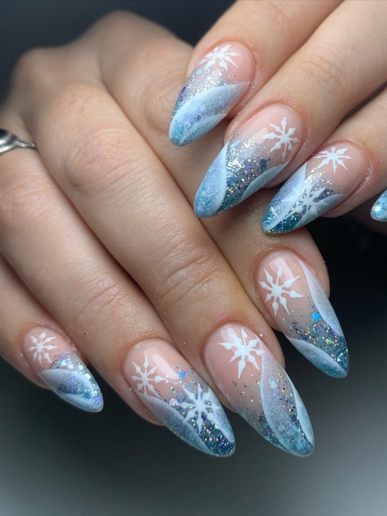 Blue winter nail colors with glitter French tips and snowflakes