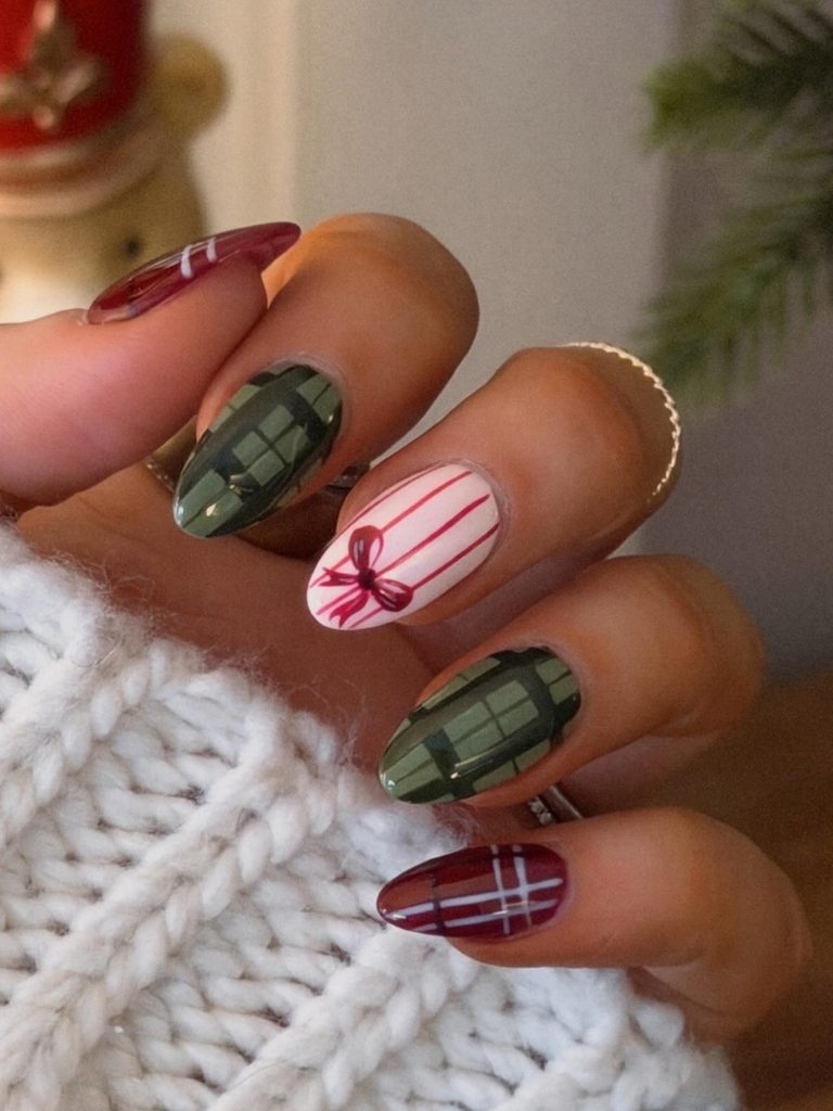 Olive green plaid nails with a pink striped bow accent