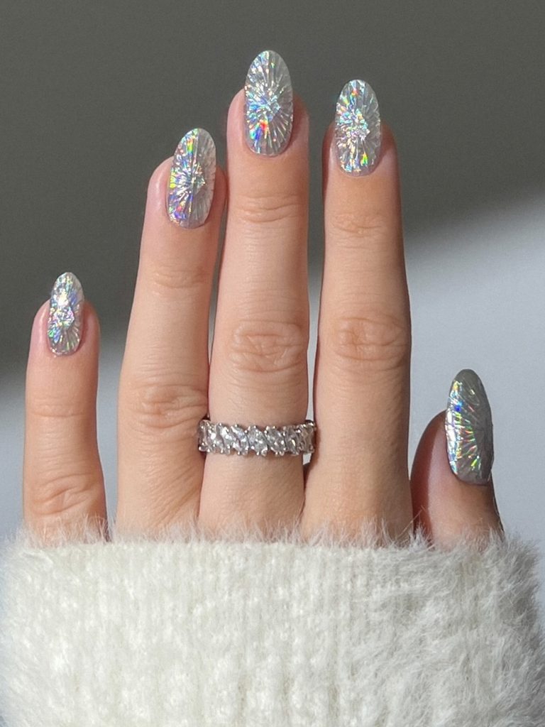 Holographic silver holiday nails with an icy shimmer