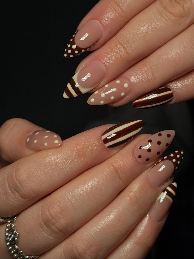Mocha brown striped and polka dot nails on almond shapes