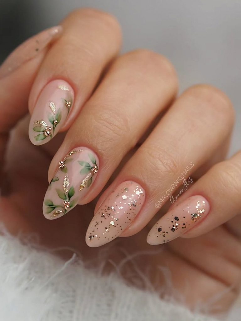 simple winter nail design with gold flecks and pine sprigs
