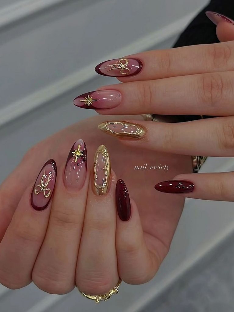 Burgundy winter nail designs with gold line art