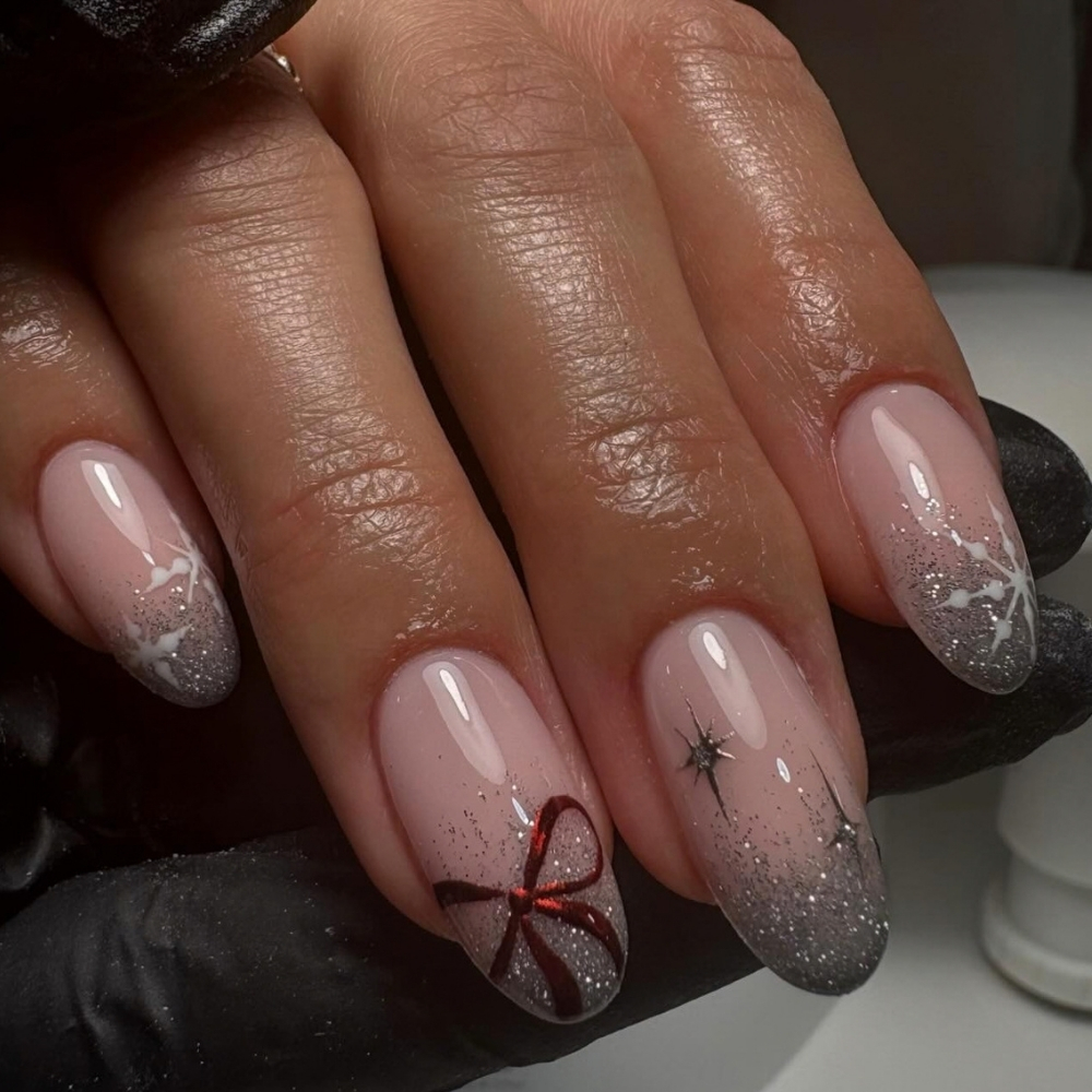 Silver ombre New Year's Eve nails with a red bow