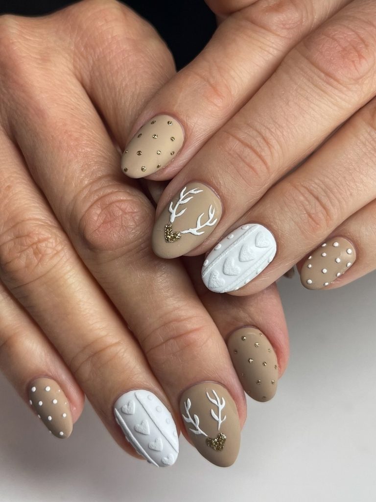 Matte mocha nails with white antlers and cable knit