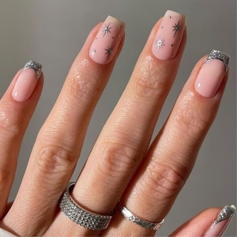 Simple winter nails with silver stars on sheer pink