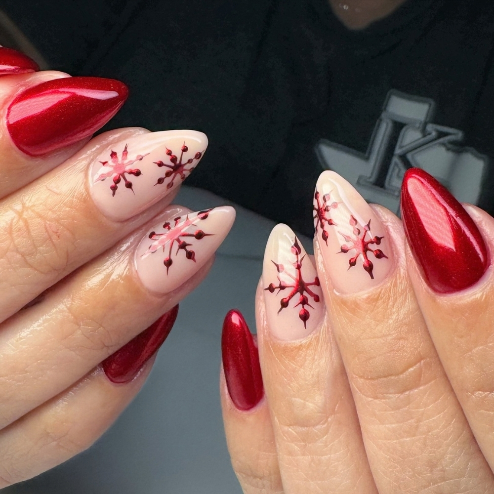 Red snowflake nails with glossy red chrome accents