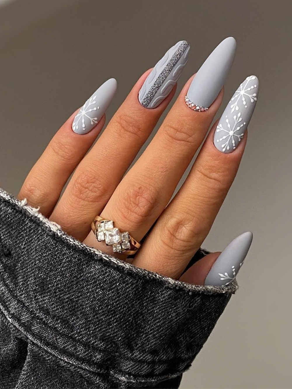 Gray winter nail design with knit texture and snowflake