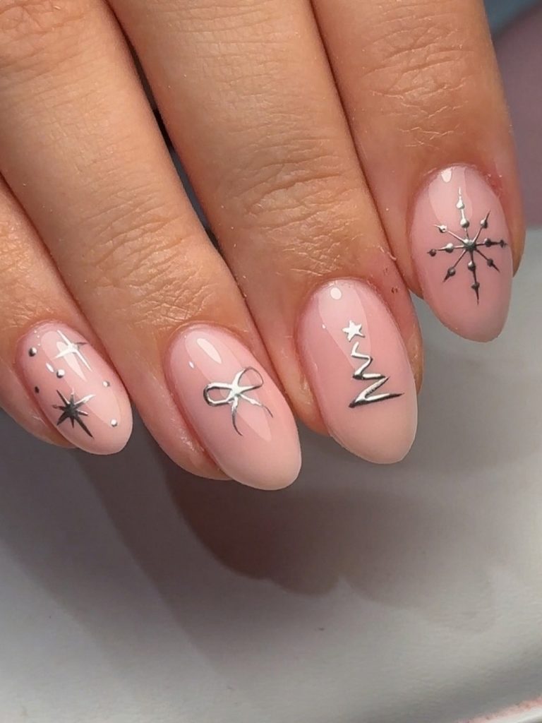 Blush winter nail art with silver foil snowflake and tree